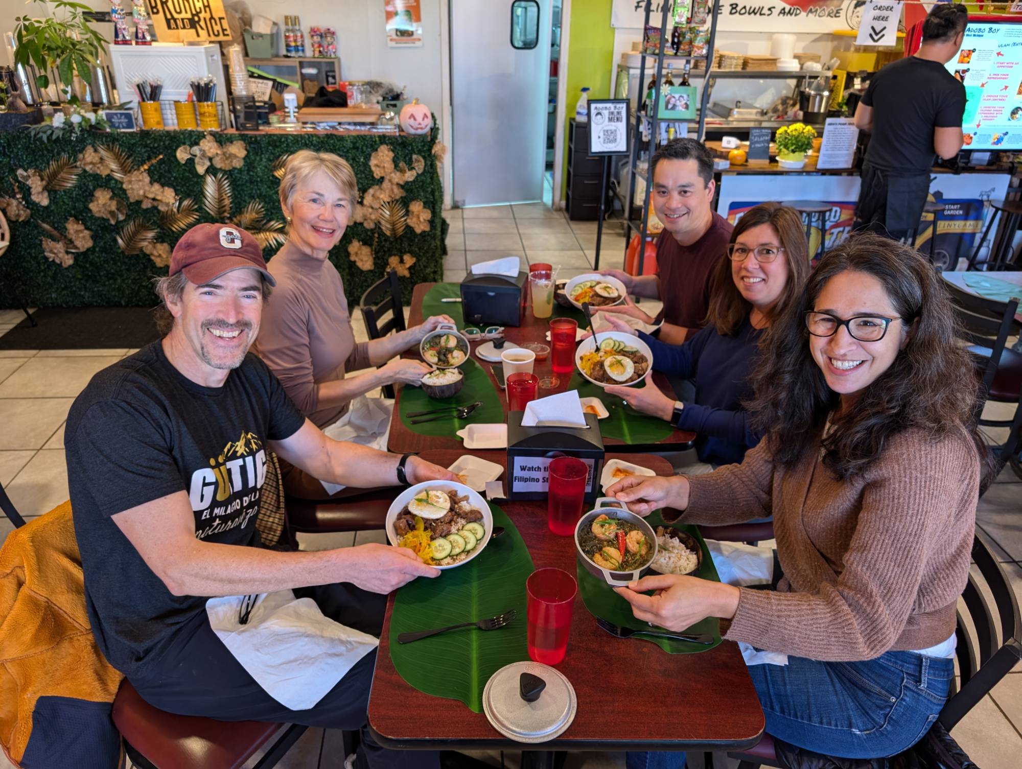 Smiling Faculty showing their Filipino dish